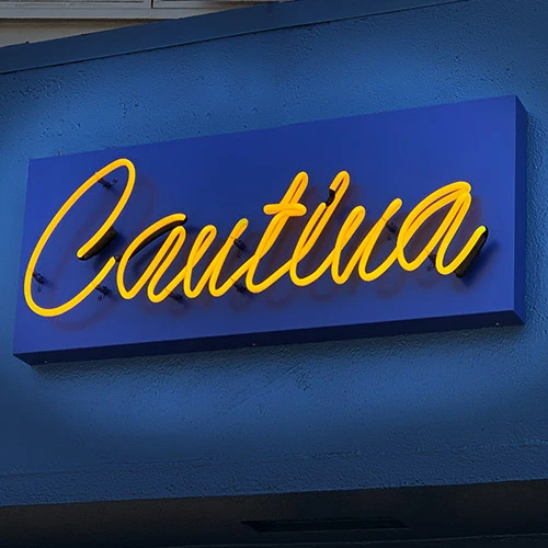 Outdoor neon sign with bright illumination.