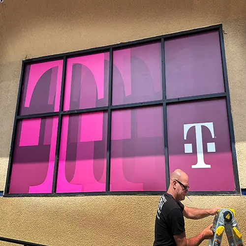 Modern magenta window advertisement design covering multiple panes, enhancing the professional look of a retail store